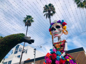 The event, organized by Downtown Santa Monica, Inc. (DTSM) will include a mix of live entertainment, art installations and activities on the Third Street Promenade, Saturday, October 30 from 5 – 10 p.m. ​​​​​​​Festivities include papel picado arts and crafts and face painting by Lil’ Bitter Pixie. In addition, there will be booths with goods from over 30 local BIPOC vendors with Angel City Market and Market Exchange, a collaboration between Santa Monica artisans Ines Garcia, Laura Hernandez, Carmela Morales and Cog•nate Collective, initiated by the 18th Street Arts Center. 